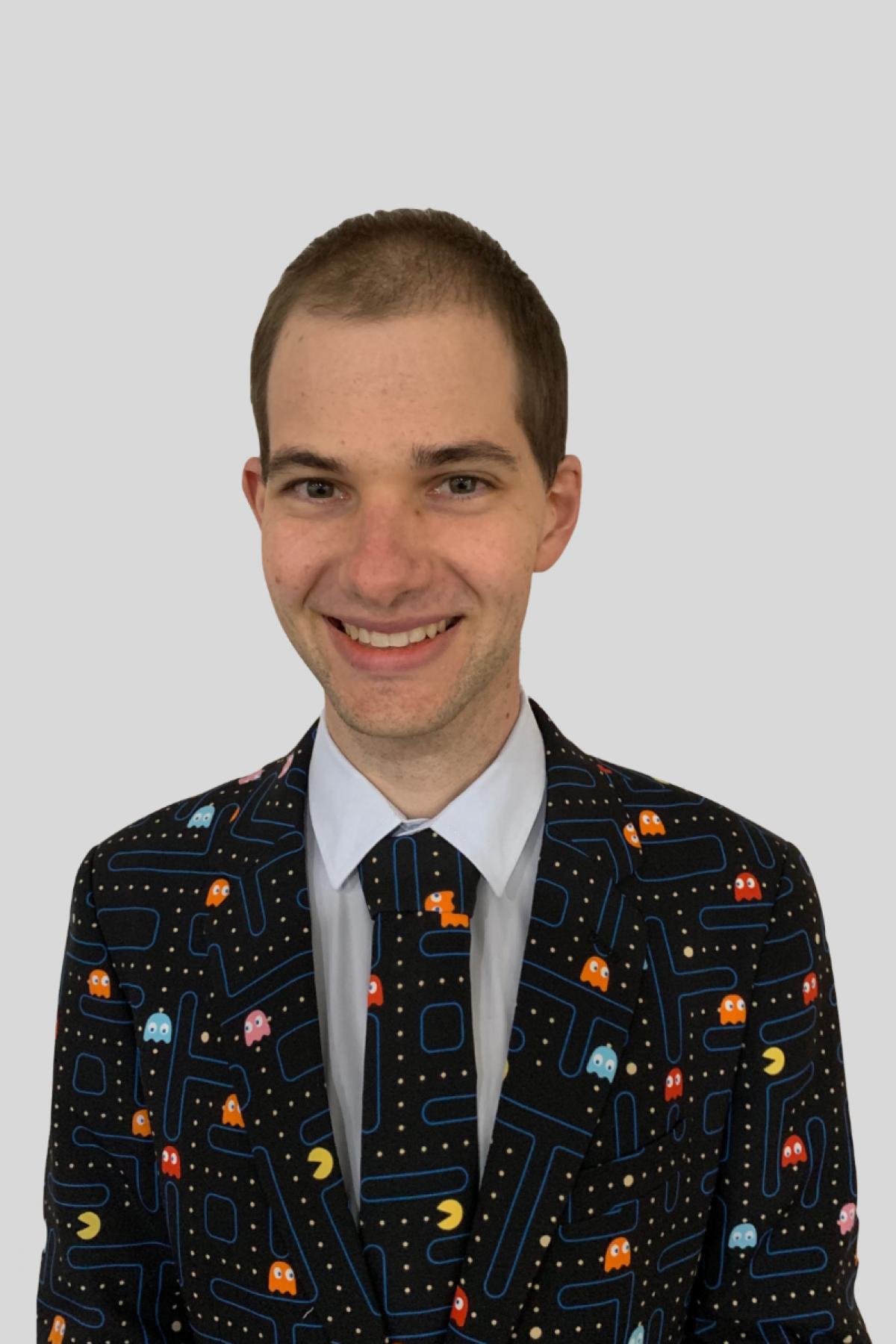 Andrew Pfeiffer's headshot. He's wearing a pac man suit and smiling widely.