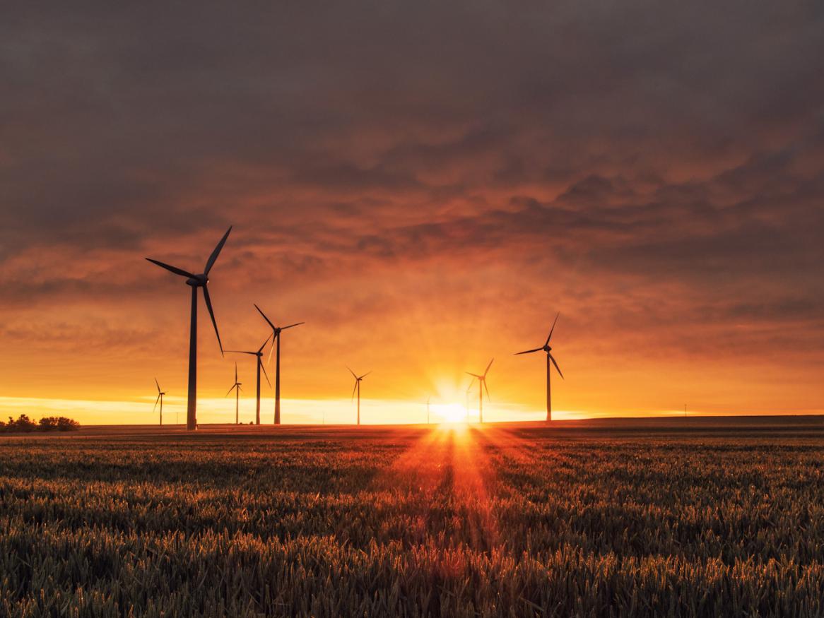 An image of wind turbine at sunset.