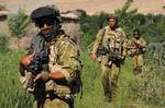 Reconstruction Task Force 4 soldiers patrol the Green Zone north of Tarin Kowt, Afghanistan. Health surveillance of Australian troops is a key aim of the Centre for Military and Veterans Health.
Photo courtesy the Department of Defence