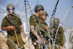 Soldiers of the Israeli Defense Force stand watch along the Security Barrier during a demonstration in the West Bank village of Bilin
Photo by iStock