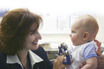 Professor Maria Makrides, pictured here with a baby at the Womens and Childrens Hospital, has won a total of $4.1 million for two separate research projects
Photo by Ben Osborne