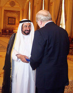 His Highness Sheikh Dr Sultan Bin Mohammed Al Qassimi accepts a gift from the Vice-Chancellor and President, Professor James McWha