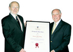 Professor James McWha (left) presents Maurice de Rohan with his Distinguished Alumni Award in London