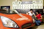 Students work on a solar-electric hybrid car
Photo by Randy Larcombe