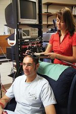 Siobhan Schabrun demonstrates the transcranial magnetic stimulation technique on physiology postdoctoral student Andrew Lavender
Photo by Candy Gibson