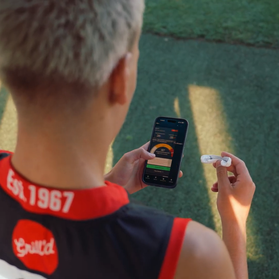 Person holding a phone and mouthguard.