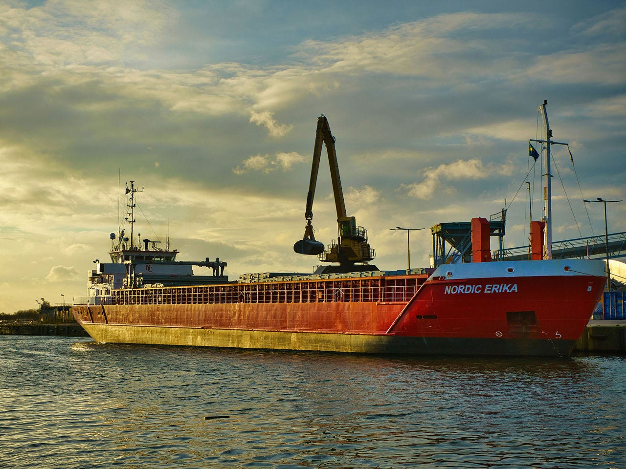 A cargo ship being loaded at the dock