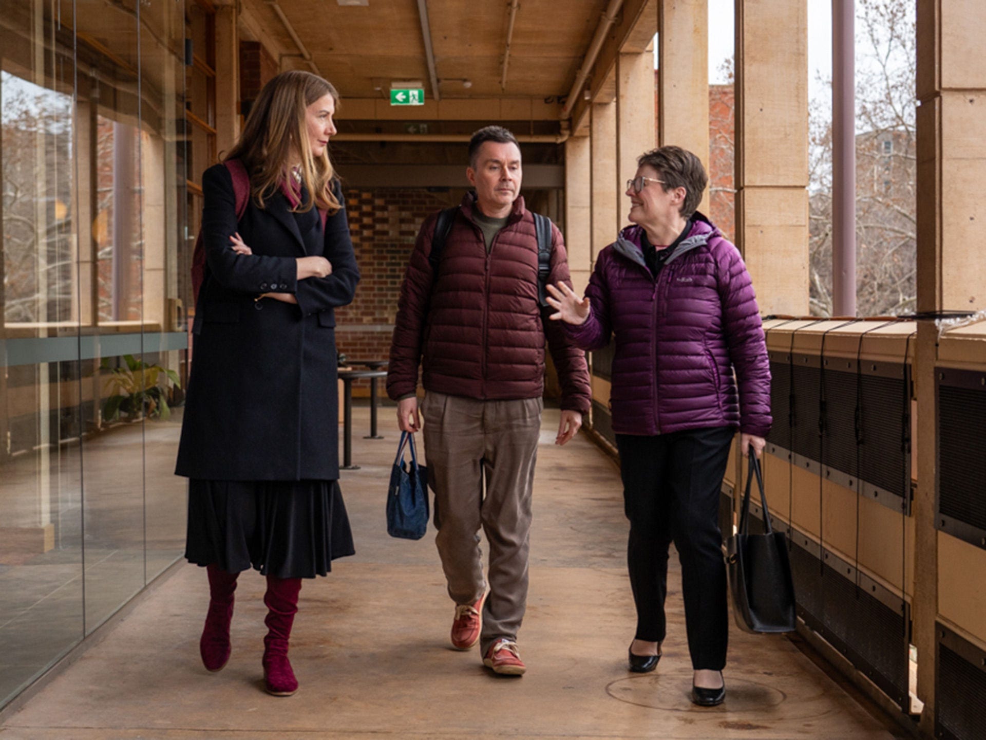 Episode 3, The future of the humanities: Professor Anna Goldsworthy, Vice Chancellor and President Nicola Phillips and Professor Craig Batty walking on campus.