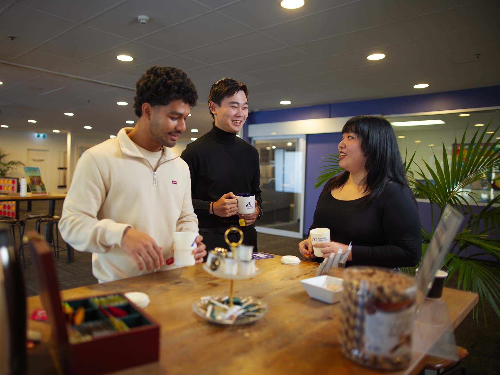 Residents using the common kitchen space at Adelaide University Village student accommodation