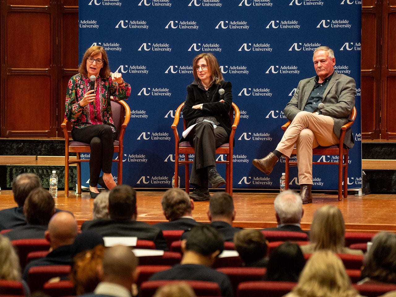 Dr Susan Close with two other panel members on stage