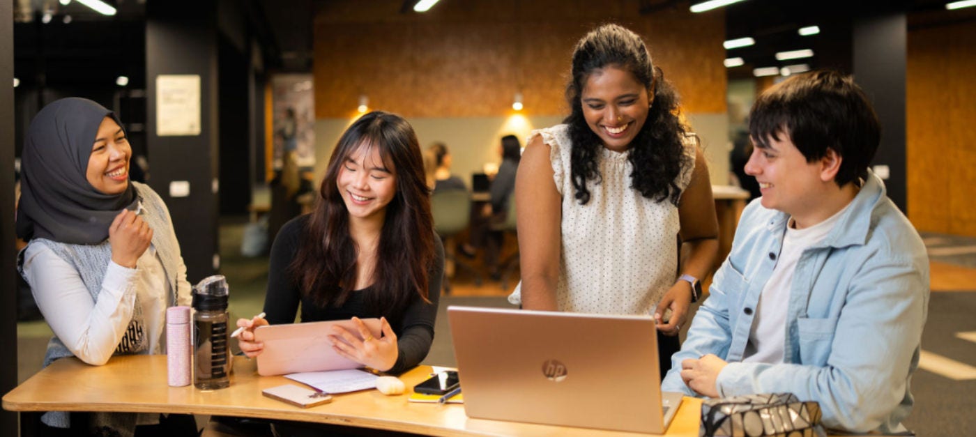 AU students sitting around a computer