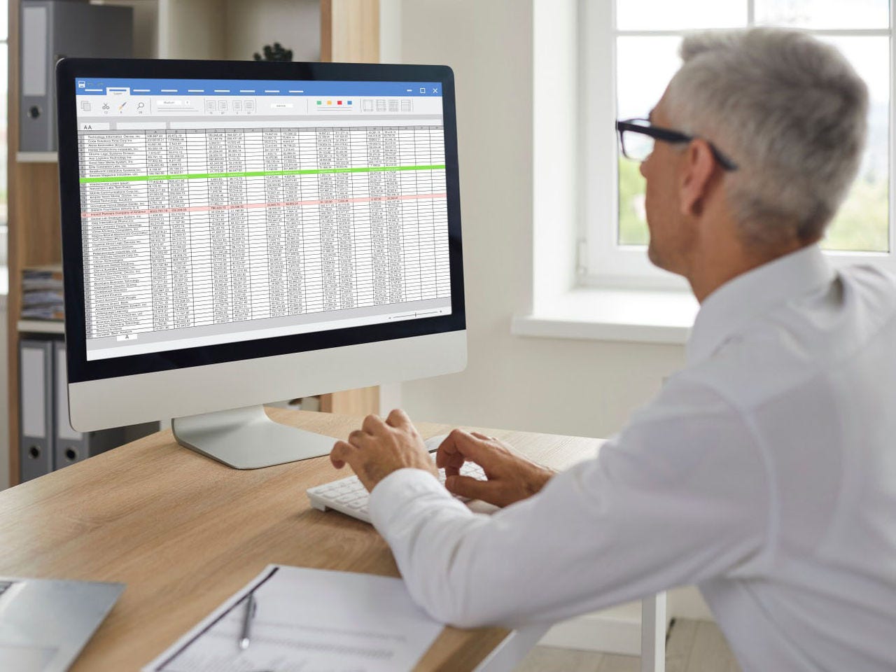 Person viewing a spreadsheet on a computer