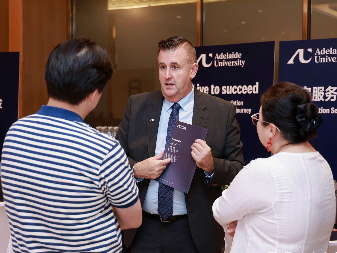 Support staff discussing accommodation options with prospective students