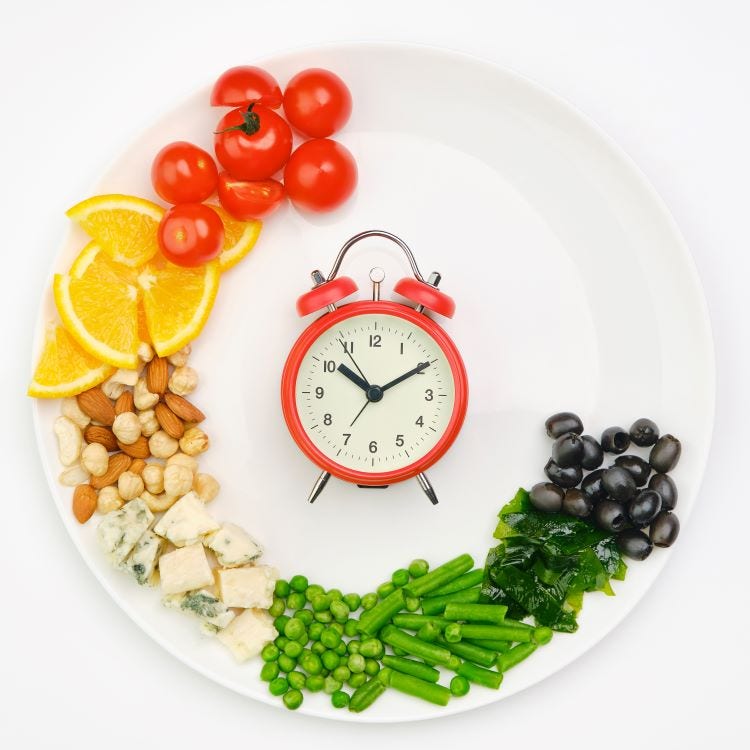Plate with fruits and vegetables and a clock in the centre