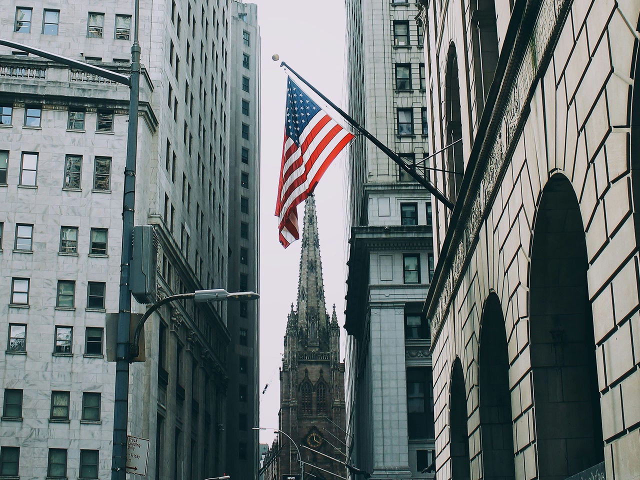 An American flag hanging from an inner-city building in New York