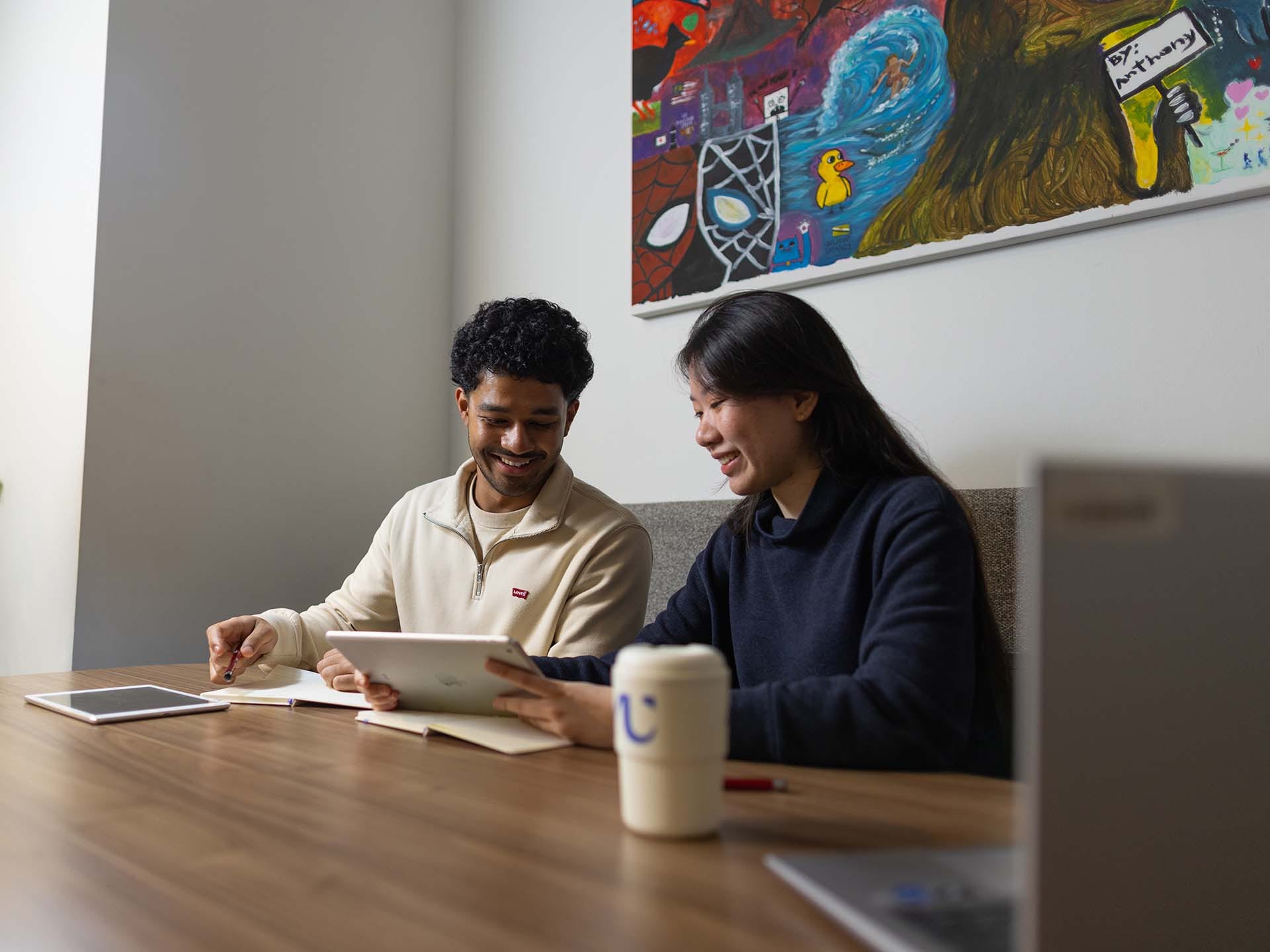 Residents studying in the shared spaces at Adelaide University Village student accommodation