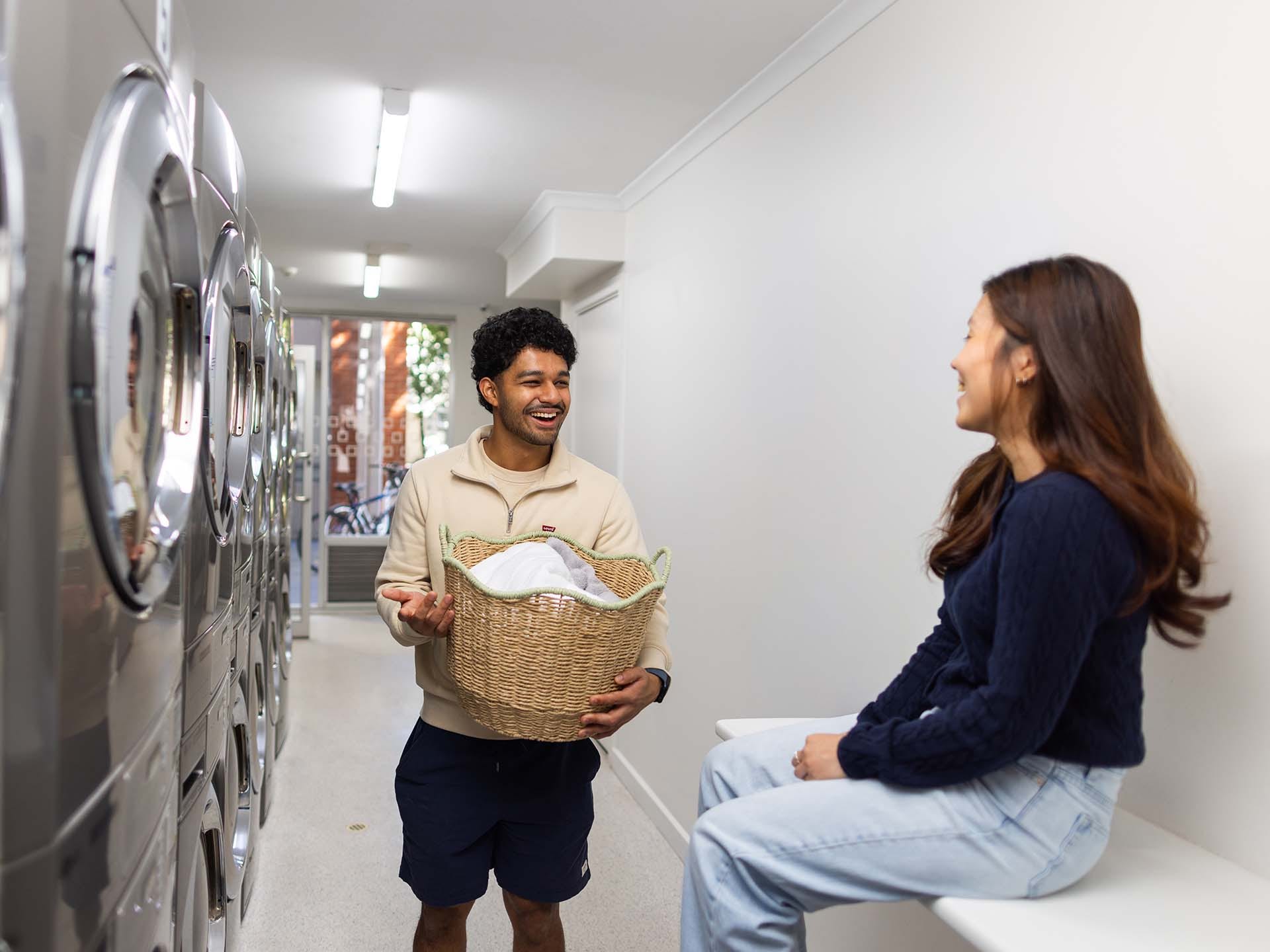Residents using the laundry facilities at Adelaide University Village student accommodation