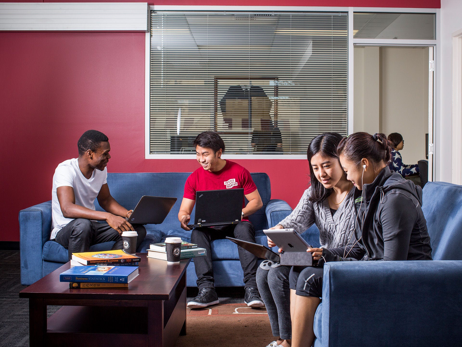 Residents using the common lounge space at Adelaide University Village student accommodation