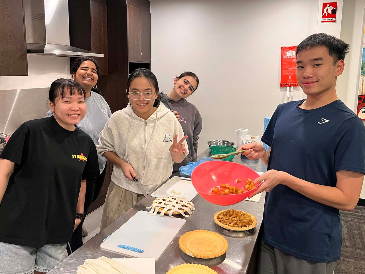 Accommodation students baking pies