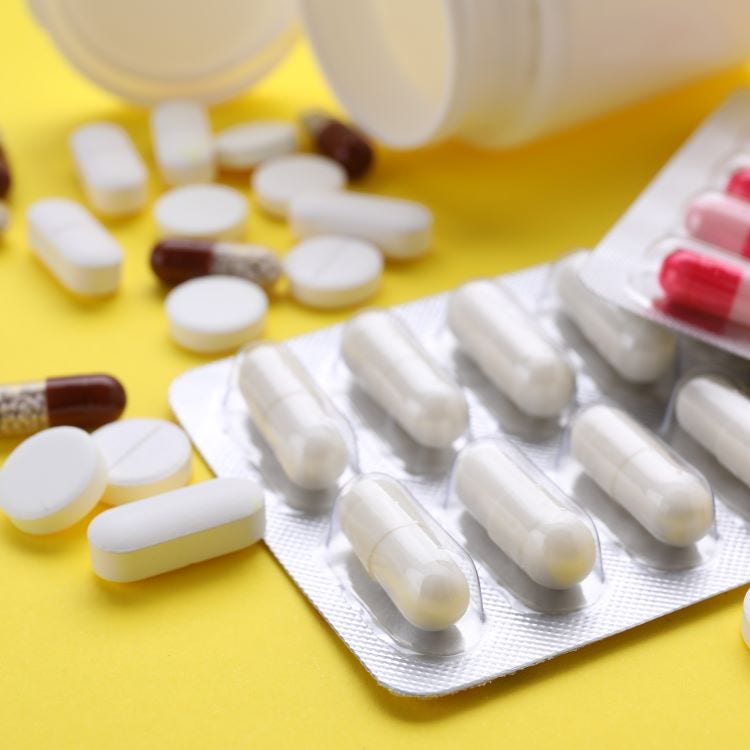 Stock image of medication in packets and spilling out of bottles.