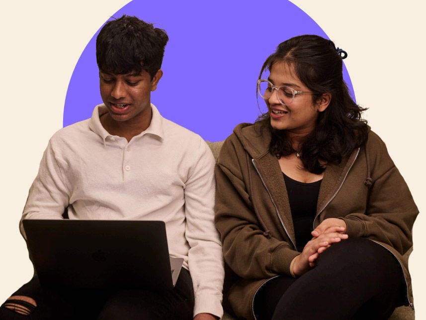 Two students looking at a laptop