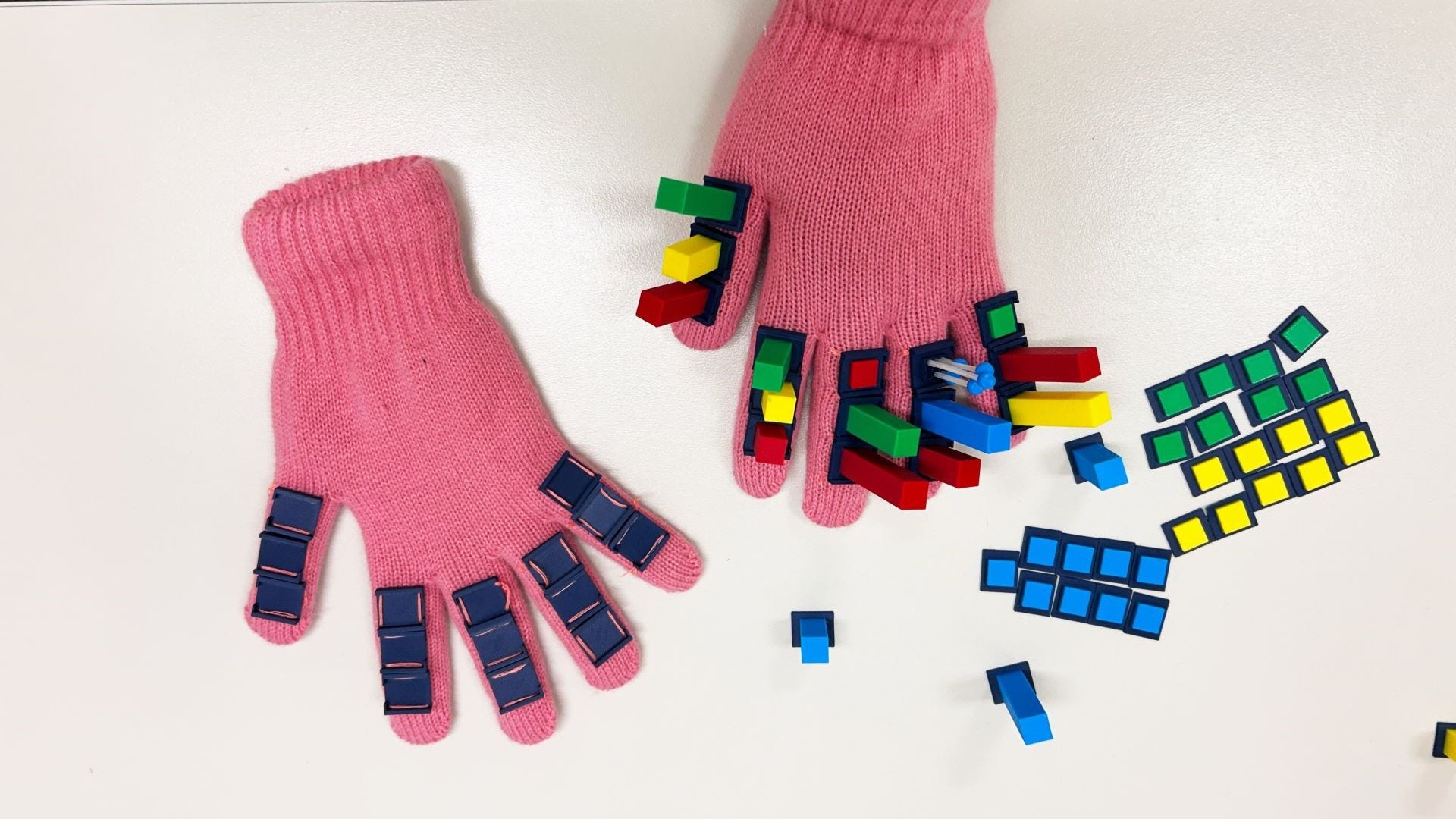 Pink glove covered with 3D printed tokens