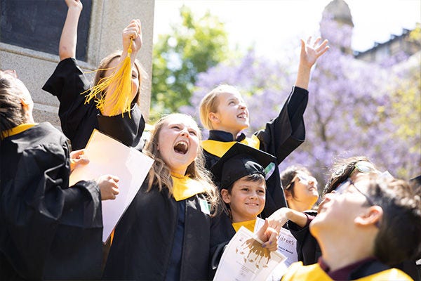Children celebrating graduating children's university