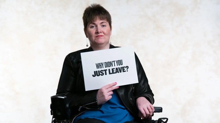 Woman holding a sign that says why don't you just leave?