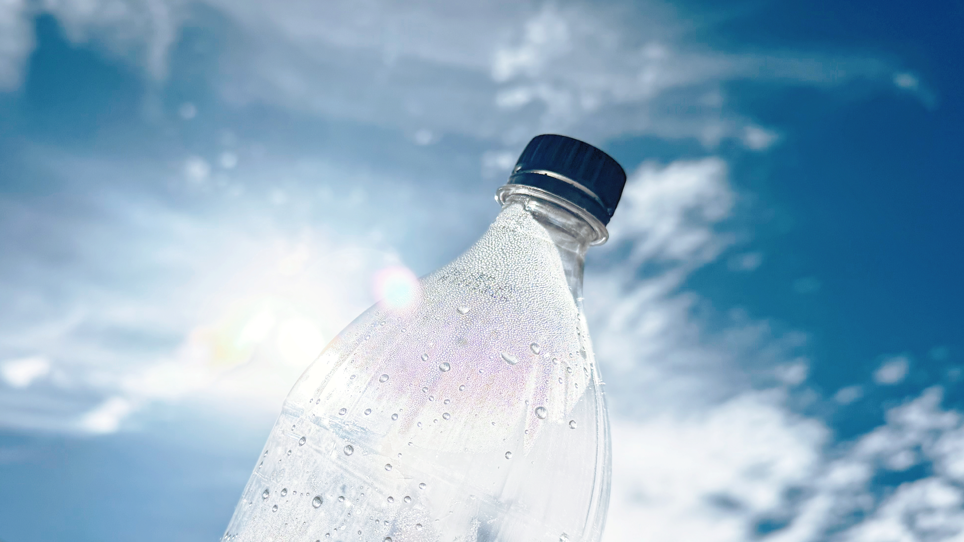Plastic bottle in the foreground of a blue sky
