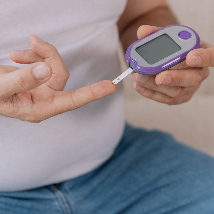 Stock image of male testing blood sugar levels