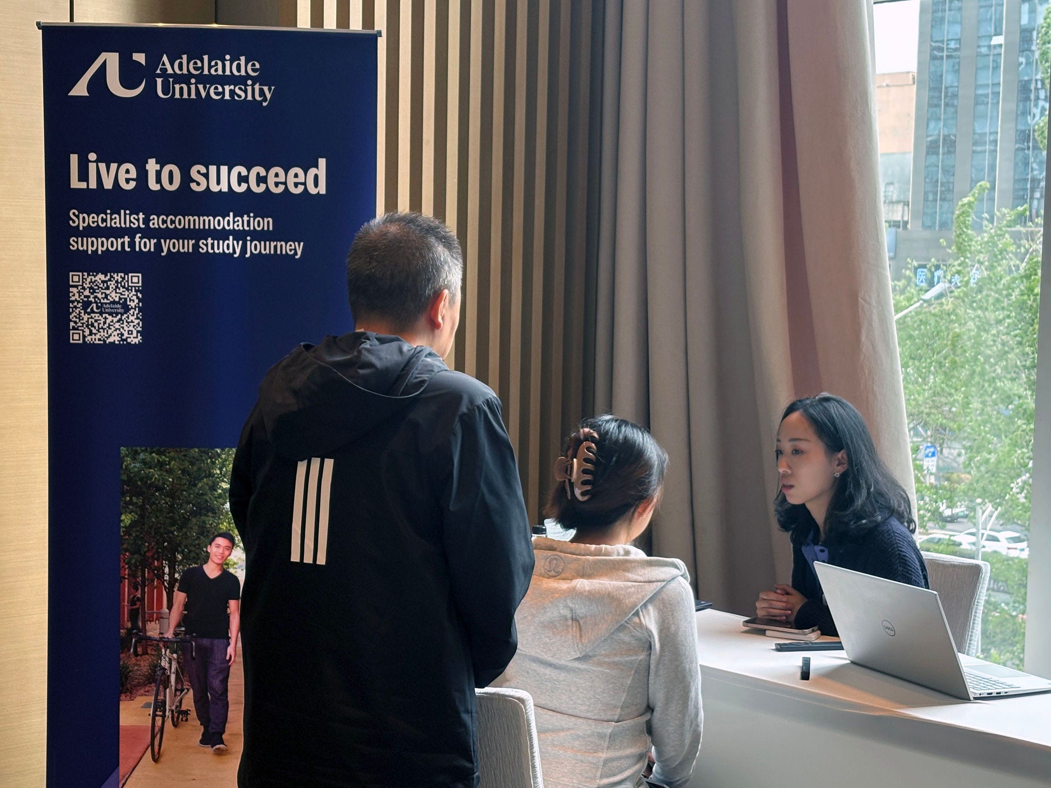 Support staff discussing accommodation options with prospective students