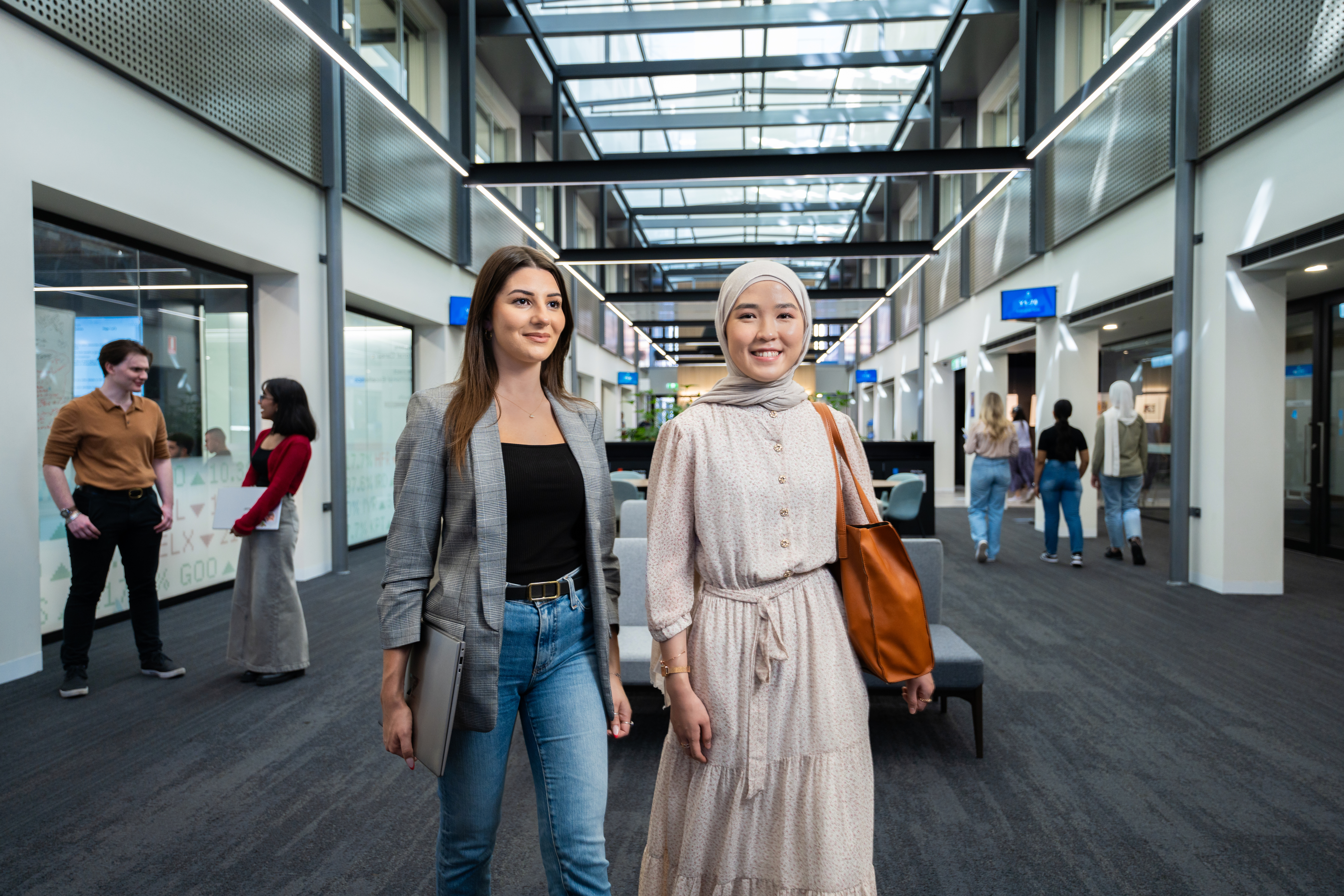 Adelaide University students in a campus hallway