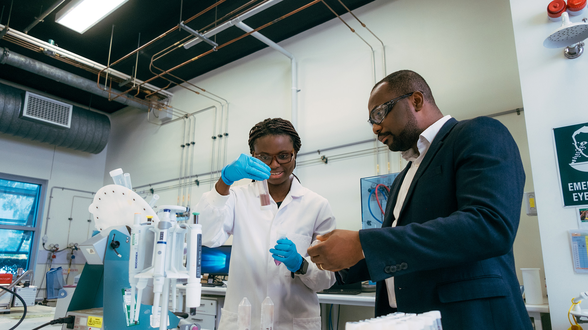 Researcher and PhD student in a lab