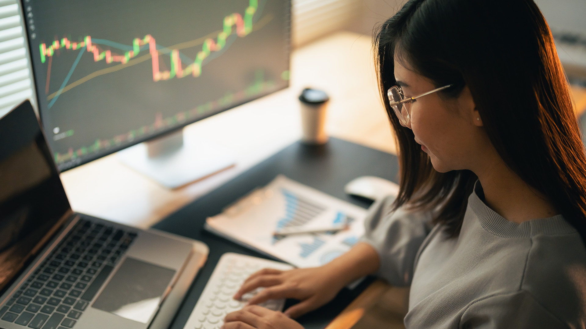Person at a laptop with economic data