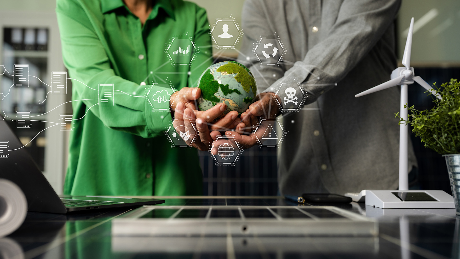Stock image of people holding a globe with other graphics around the globe