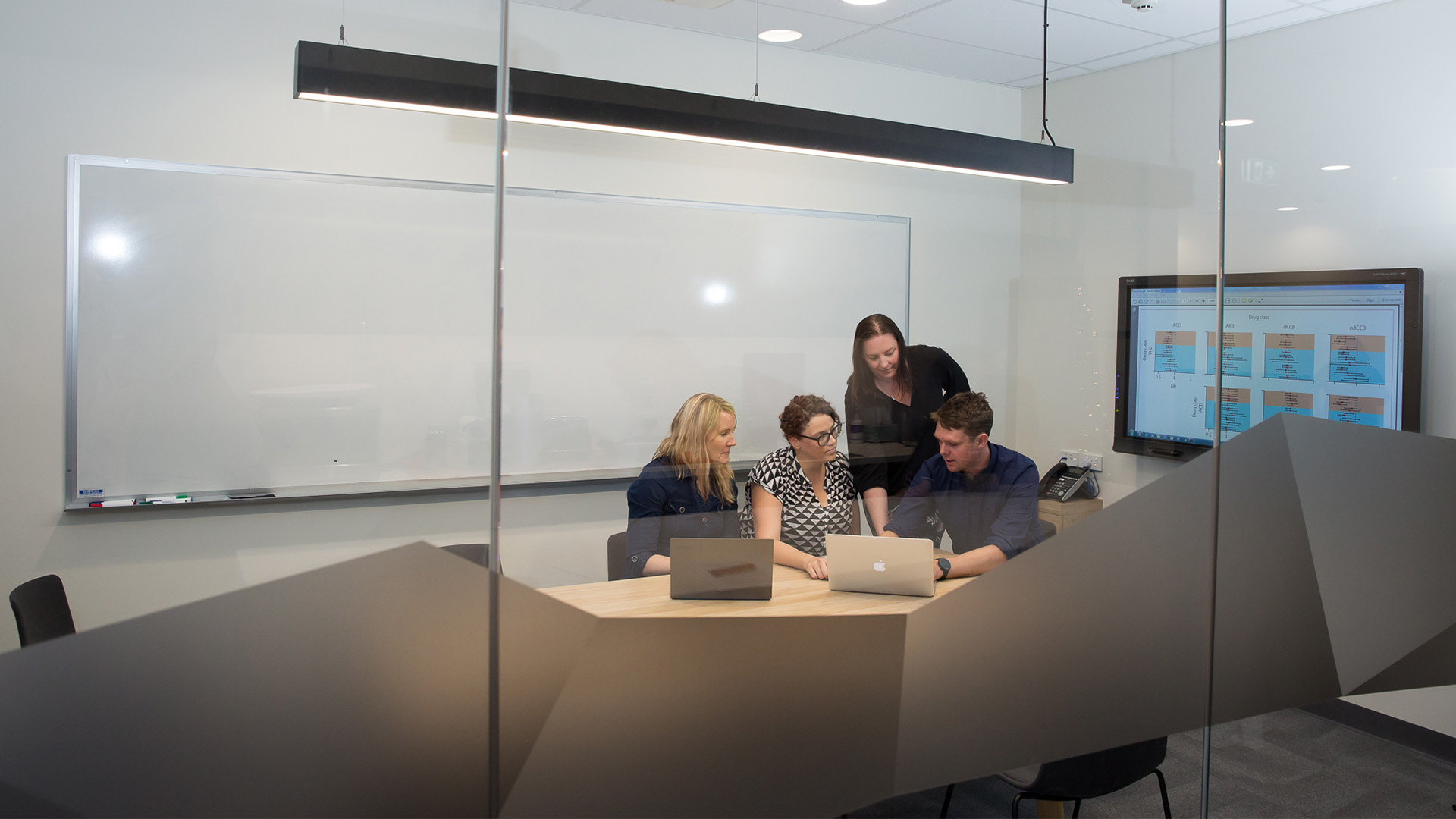 QUMPRC researchers in a meeting