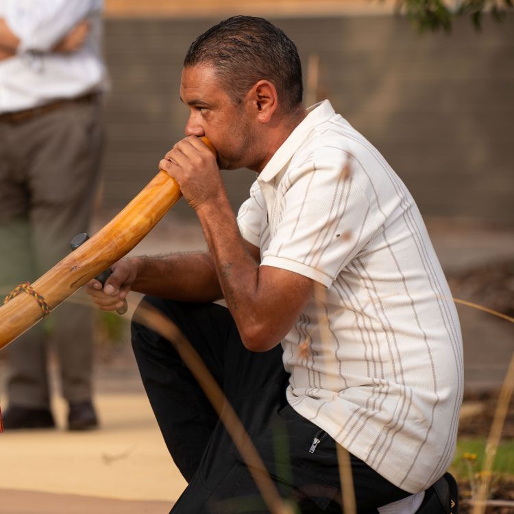 Man addressing a small crowd at the Yarning Circle ceremony at Roseworthy Campus