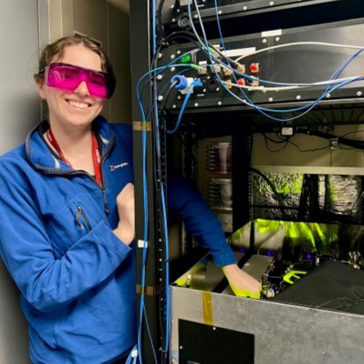 People standing in front of a navy ship