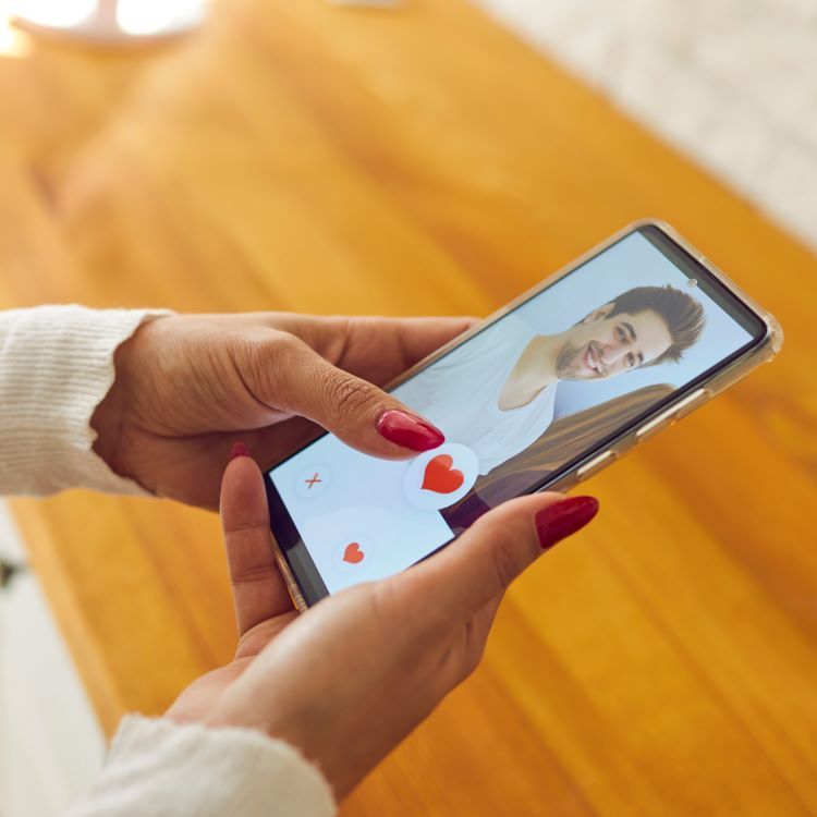 A woman using the Tinder dating app