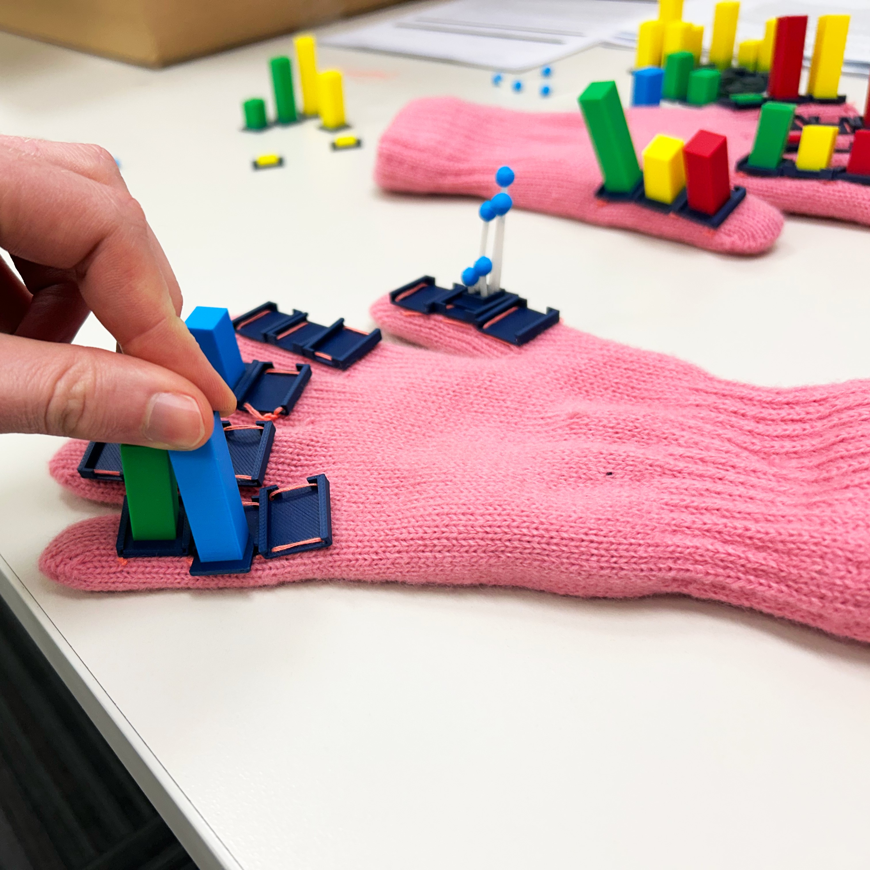 Pink glove with 3D printed tokens on the outside