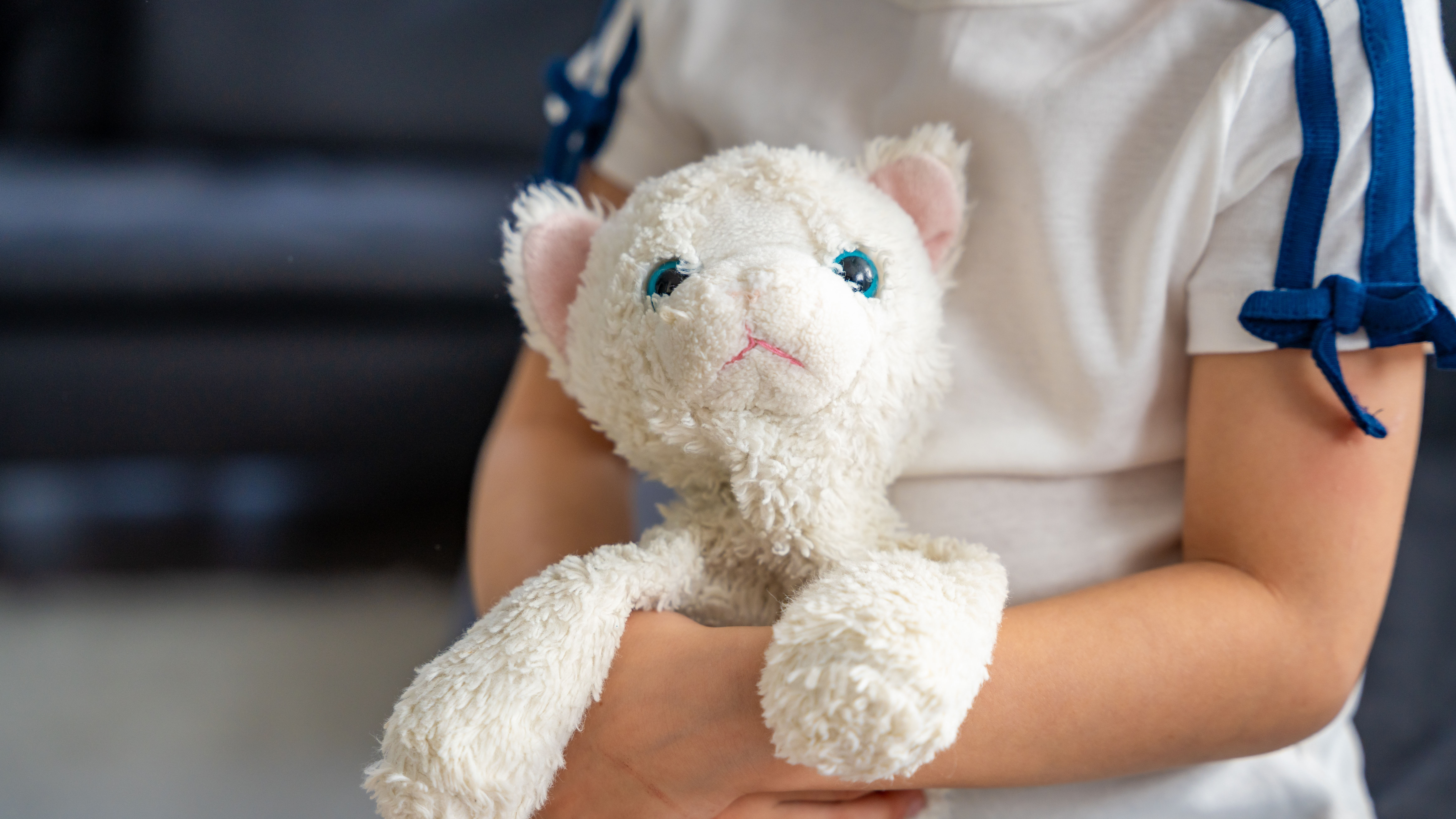child holding teddy bear