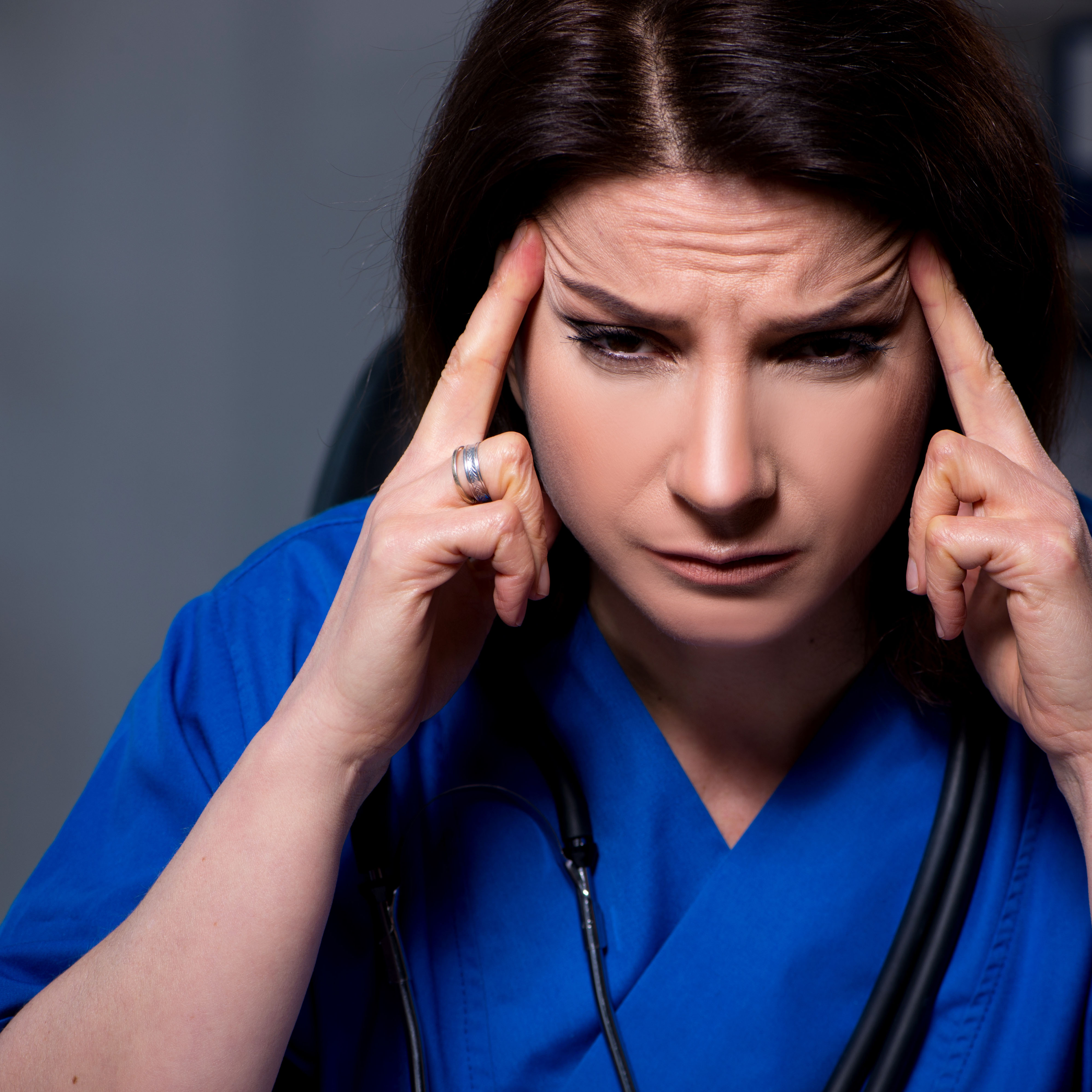 Tired and stressed woman on night shift at hospital