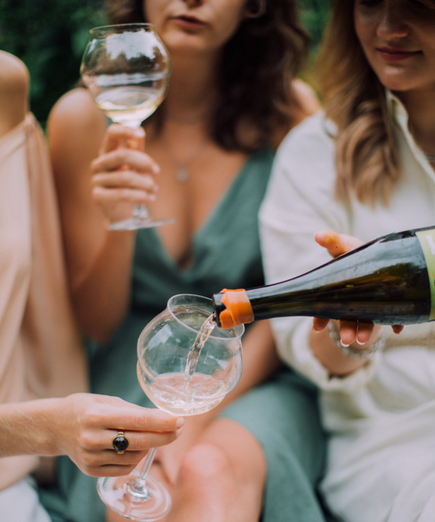 Women hold wine glasses