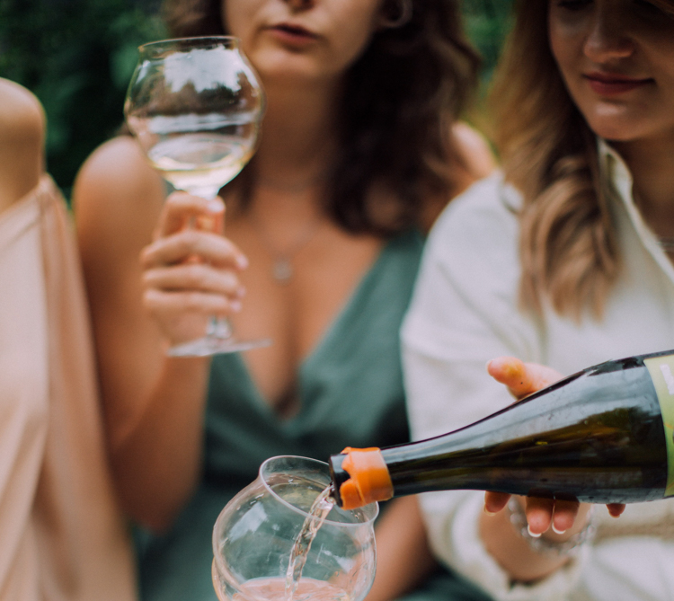 Women hold wine glasses