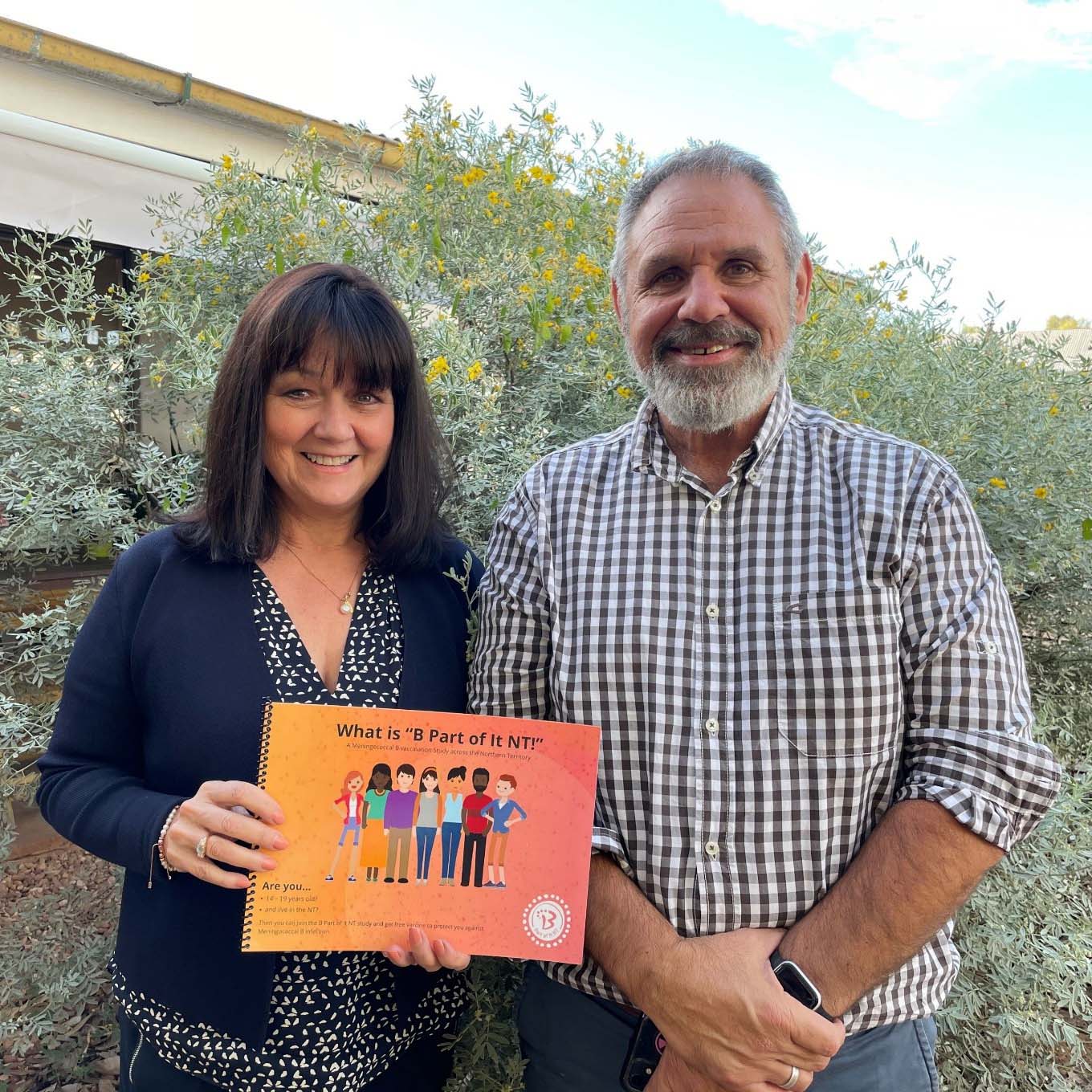 Photo of Professors Helen Marshall and James Ward holding a study advertisement.