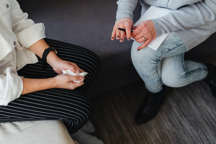 Two women sit on a couch