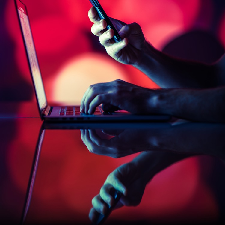 Person using laptop and phone