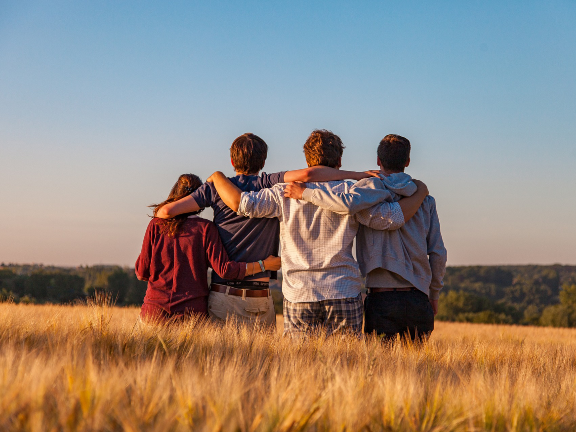 young people in a field - image