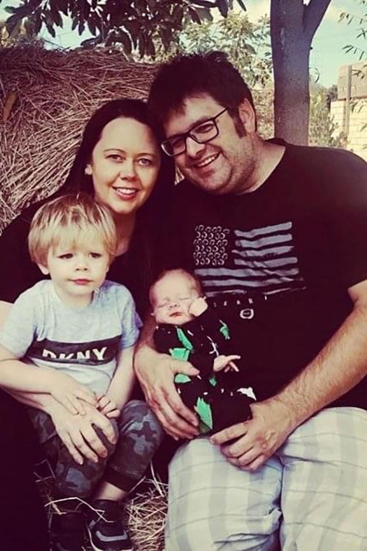 Linda with her husband and two young children weeks before her diagnosis