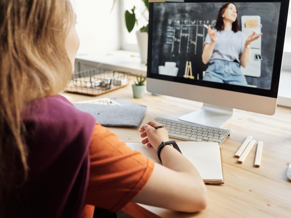 Girl learning from video on computer